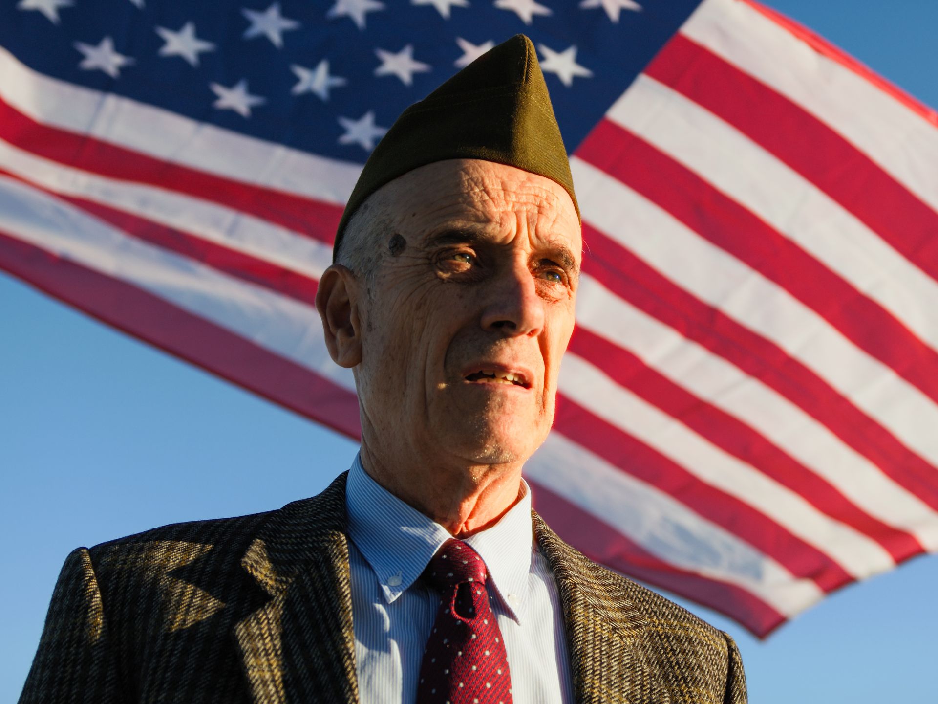 Senior veteran standing in front of the American flag
